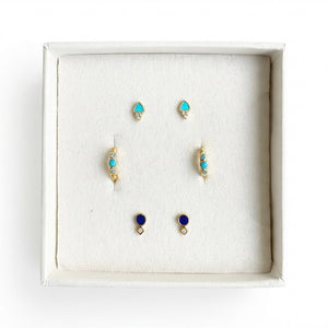Set of earrings with blue and gold accents in a white box