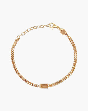 Gold chain bracelet with a rectangular Citrine yellow baguette cut gemstone centre stone on a white background