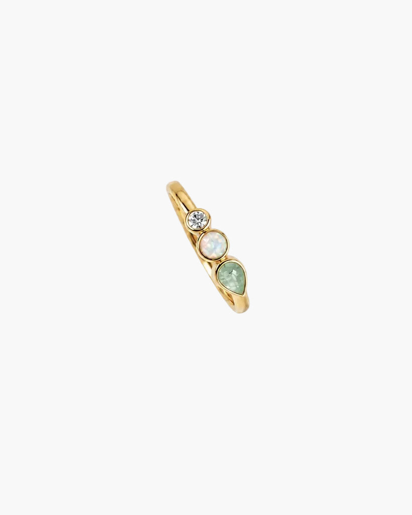 A gold ring with three small light green marquise-cut gemstones clustered at the top, photographed on a clean white background.