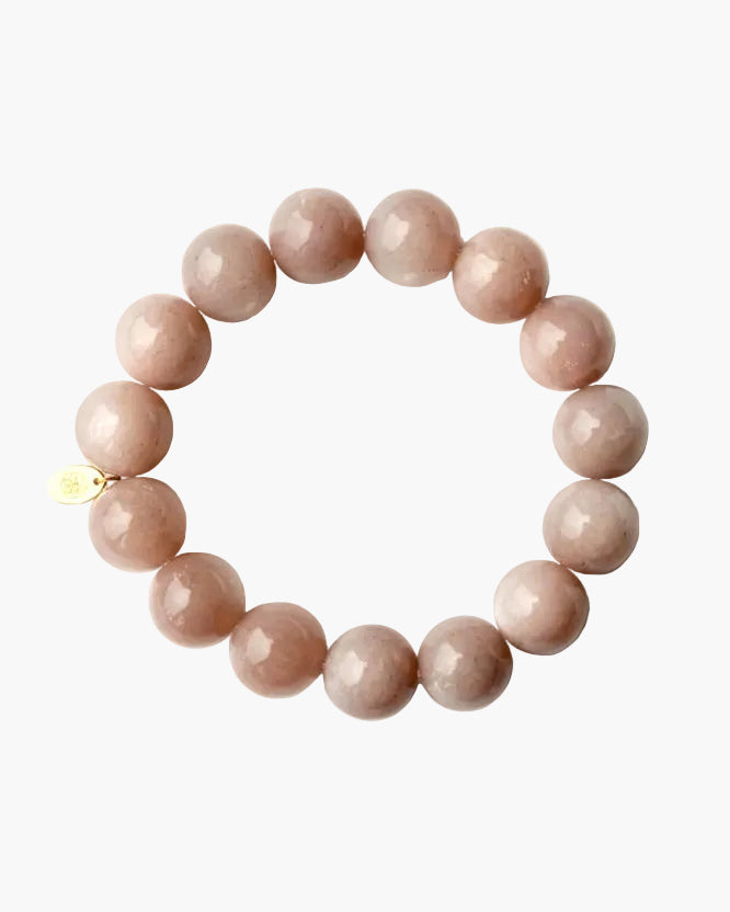 Pink beaded bracelet on a light grey background