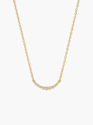 Gold tennis curved bar chain necklace on a light gray background