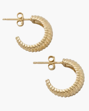 Gold hoop earrings on a light gray background