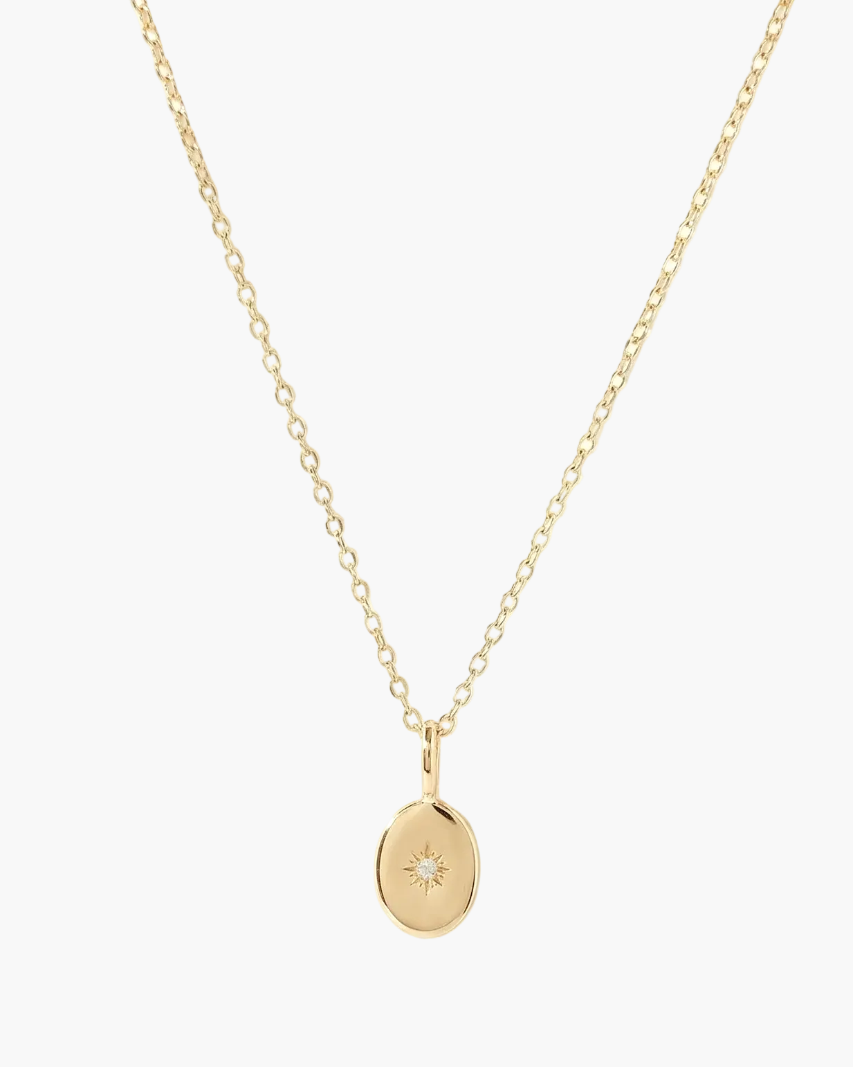 Gold necklace with a small pendant on a white background