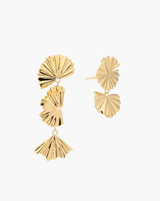 gold leaf mix and match drop earrings on a neutral background
