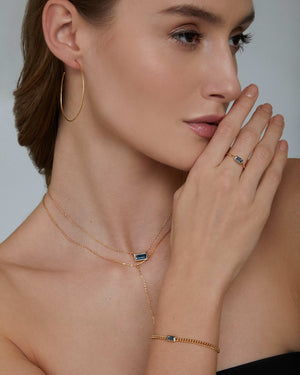 woman wearing Gold plated sterling silver large hammer hoop earrings