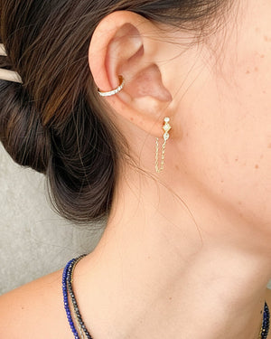 woman wearing opal chain earrings and an ear cuff
