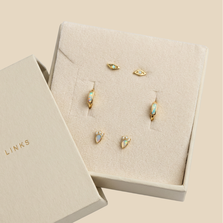 opal earrings set including 2 stud pairs and a pair of huggie hoop earrings in a Karma Links jewellery beige box