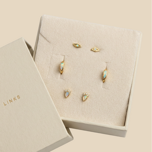opal earrings set including 2 stud pairs and a pair of huggie hoop earrings in a Karma Links jewellery beige box