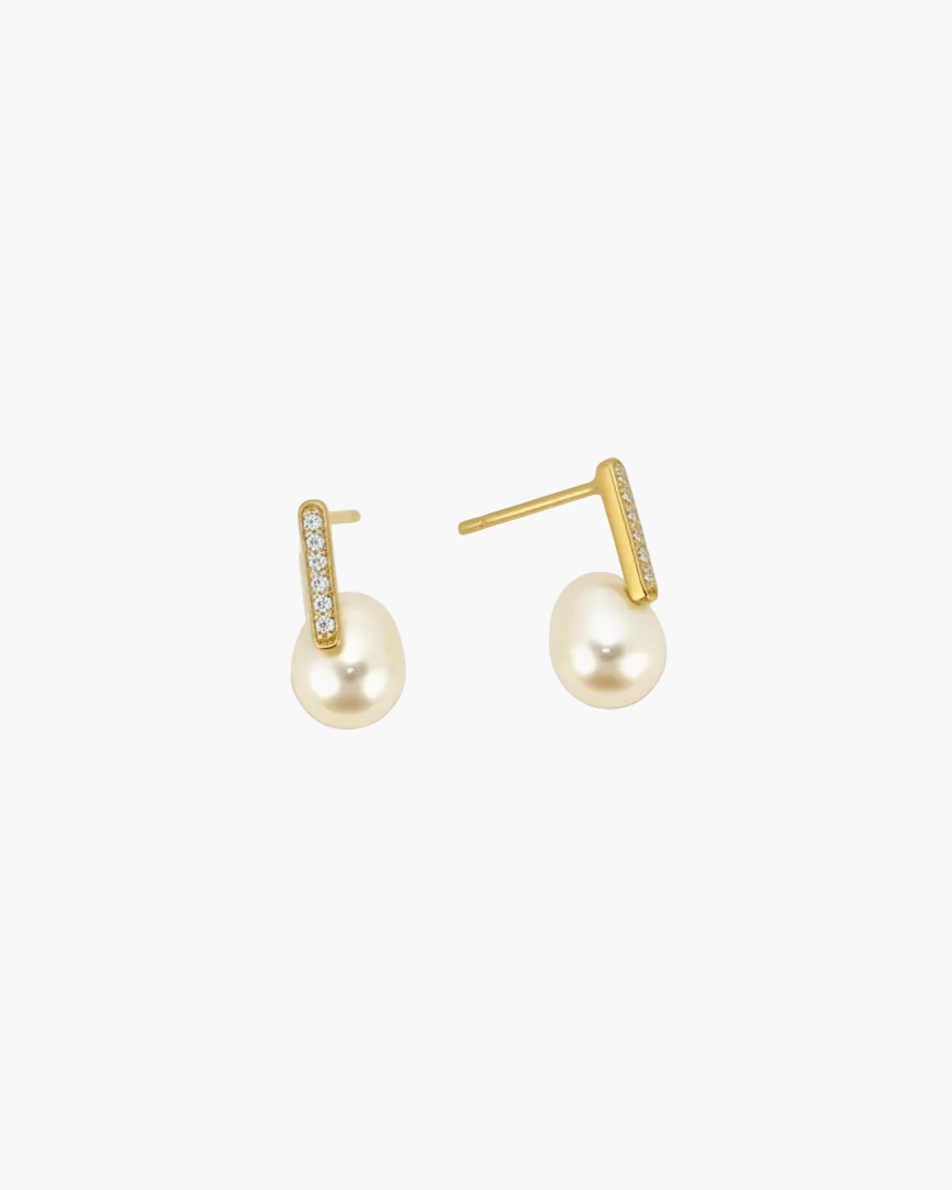 Pair of pearl earrings with gold accents on a white background