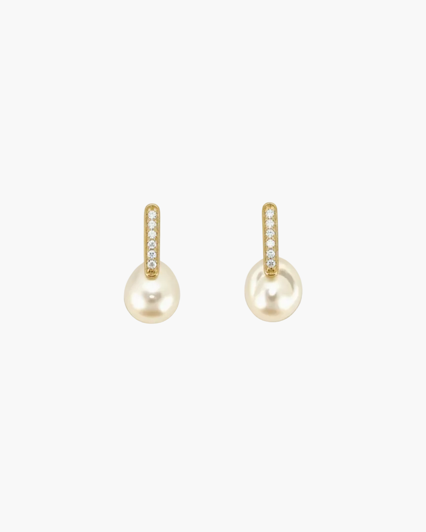 Pair of pearl earrings with gold accents on a white background