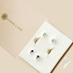 Jewellery set in a 'Karma Links' box on a light grey background