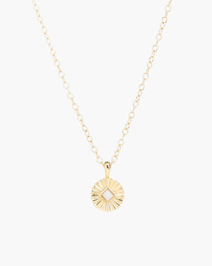 Soleil charm necklace with Opal center stone on light grey background