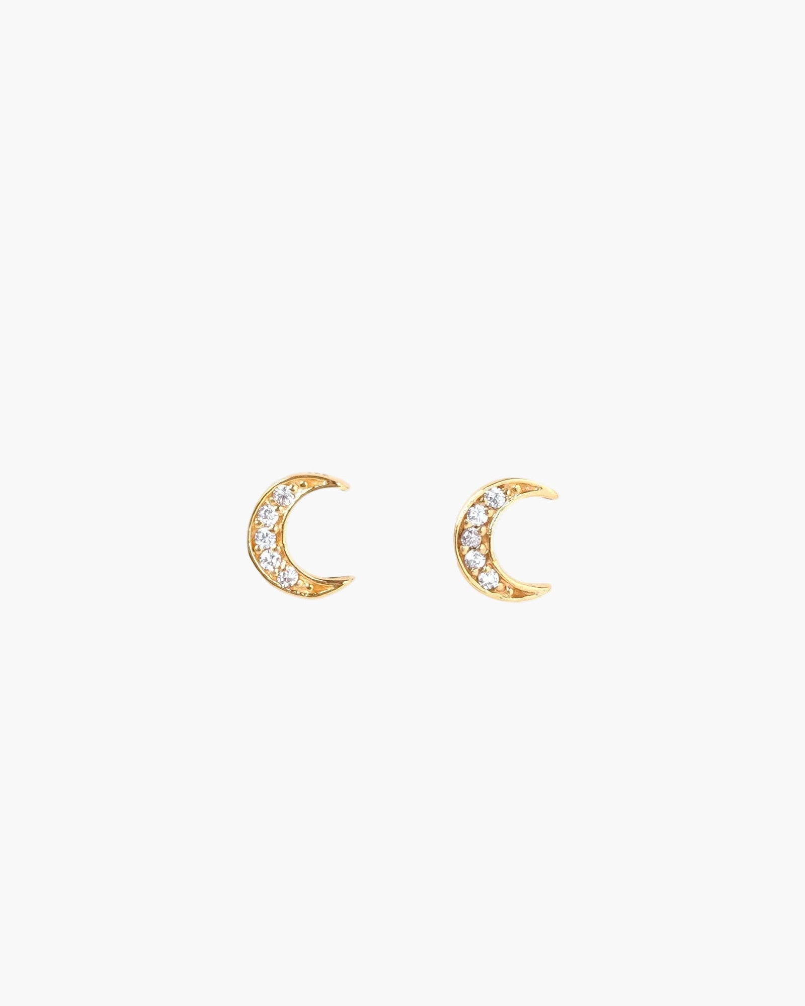 crescent moon studs on light grey background