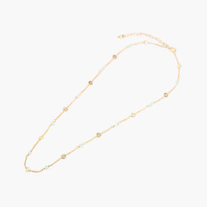gold aqua blue gemstone disk necklace on light grey background