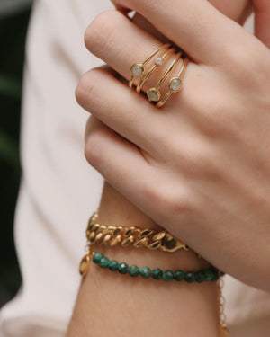 close of woman's hand with bracelets and ring
