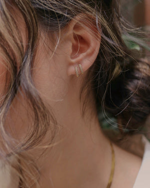 two pave bar hoop earrings on a single ear 