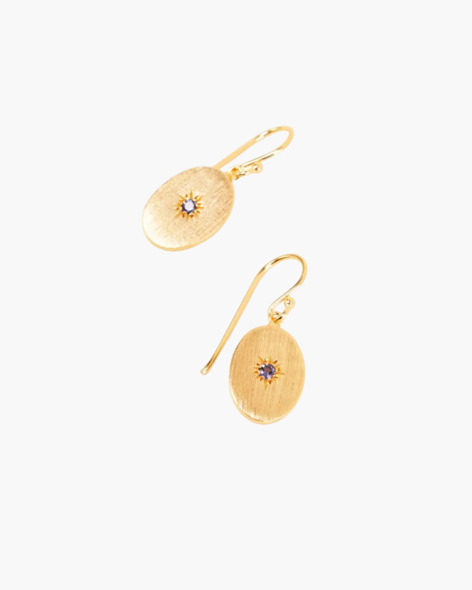 sapphire guiding star drop earrings on light grey background