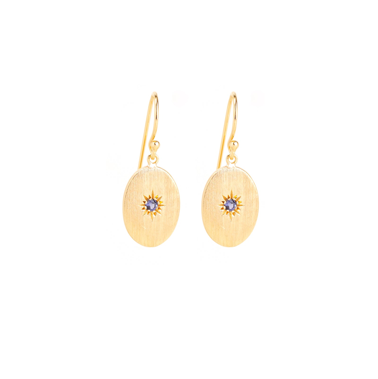 sapphire guiding star drop earrings on light grey background